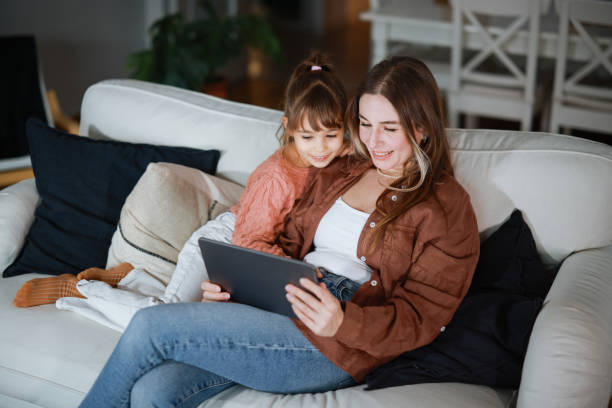istock Mother and daughter using a digital tablet together 2194970347