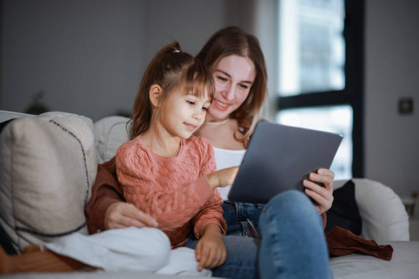 istock Mother and daughter using a digital tablet together 2194970940