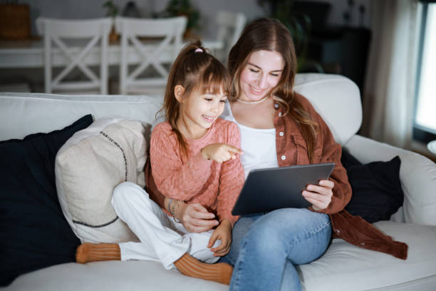 istock Mother and daughter using a digital tablet together 2194970971