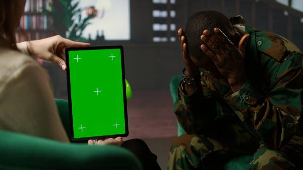 istock Black army soldier crying at therapy session next to chroma key screen 2194972884