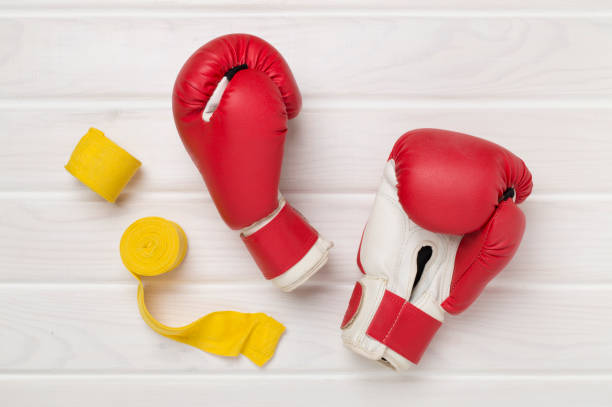 istock Red boxing gloves on wooden background, top view. 2194975398