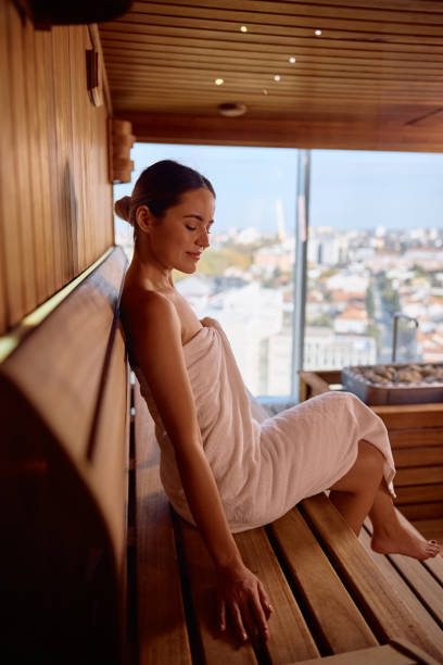 istock Young woman enjoying in sauna while spending a day at the spa. 2194976252