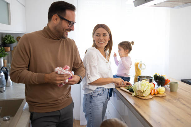 istock Family Cooking Together in a Bright Modern Kitchen Space 2194981294