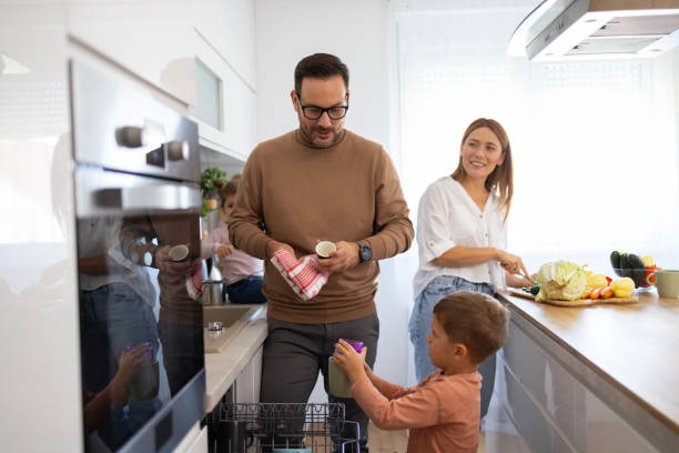 istock Family Cooking Together in a Modern Kitchen Scene 2194981329