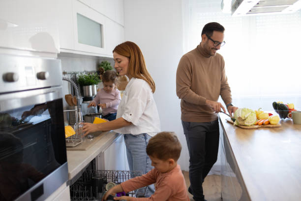 istock Smiling Family Members Participating in Kitchen Tasks 2194981335