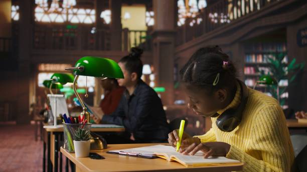 istock African american schoolgirl using fluorescent pen to highlight key words 2194983490