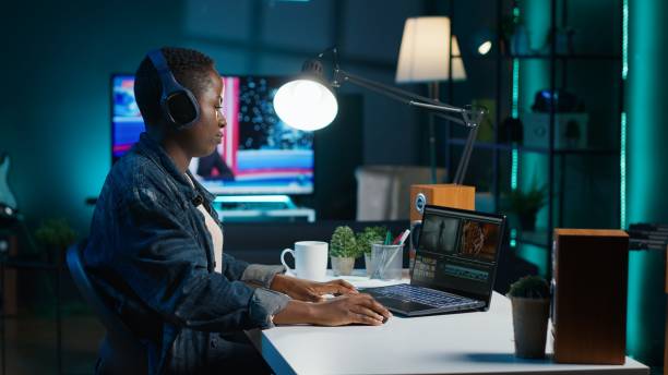 Video editor adds sound effects to filmed footage, wearing headphones Video editor adds sound effects to filmed footage, working in home studio. Videographer using headphones to test and improve audio quality, editing clips with professional software, camera A female film editor stock pictures, royalty-free photos & images