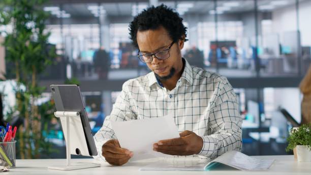 istock Confident businessman at his office desk working on report writing 2194986990