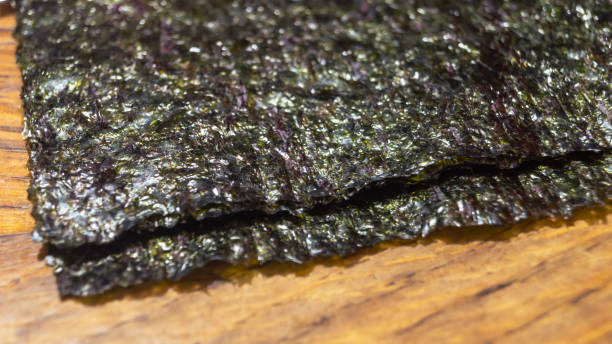 istock Nori algae leaves on a wooden table closeup 2194990031