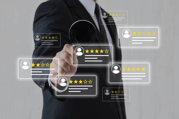 istock Businessman analyzing customer reviews with magnifying glass 2194992644