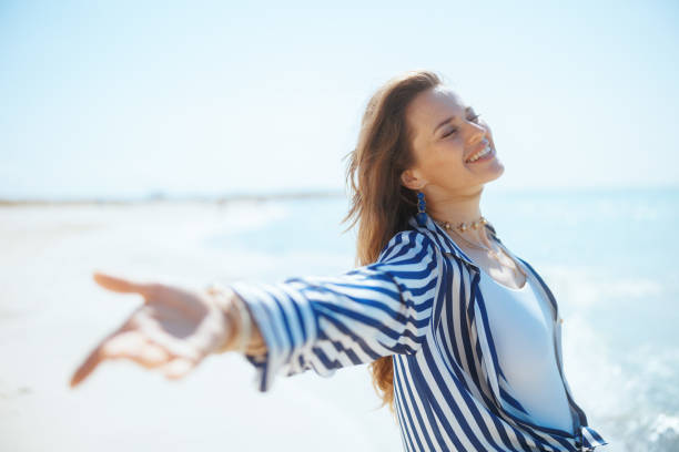 istock stylish female on ocean coast rejoicing 2194992833