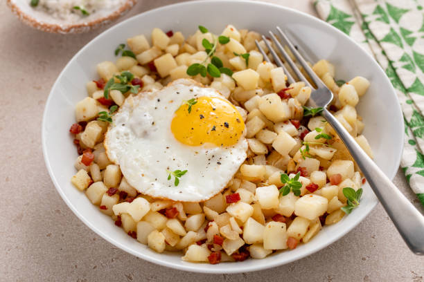 istock Classic breakfast potato hash with fried egg and ham or bacon 2194993534