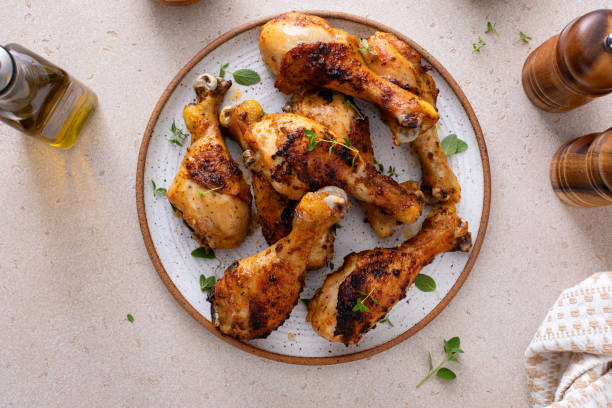 istock Juicy roasted or grilled chicken drumsticks on plate 2194993542