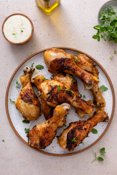 istock Juicy roasted or grilled chicken drumsticks on plate 2194993840