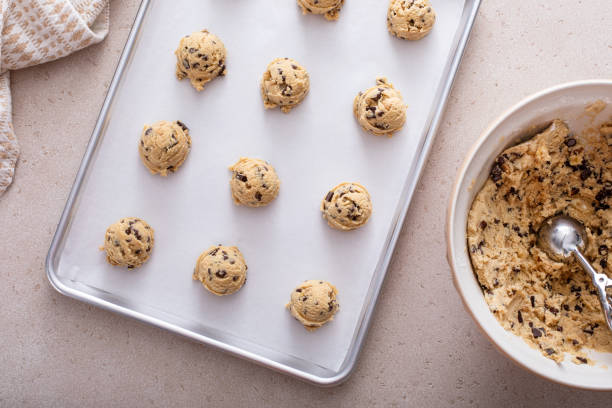 istock Scoops of cookie dough on baking sheet 2194993850