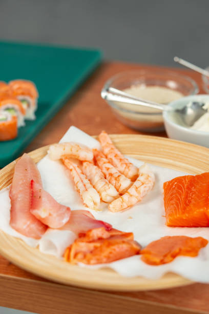istock Fresh seafood assortment featuring salmon, shrimp, and various fish cuts prepared for culinary use 2194994050