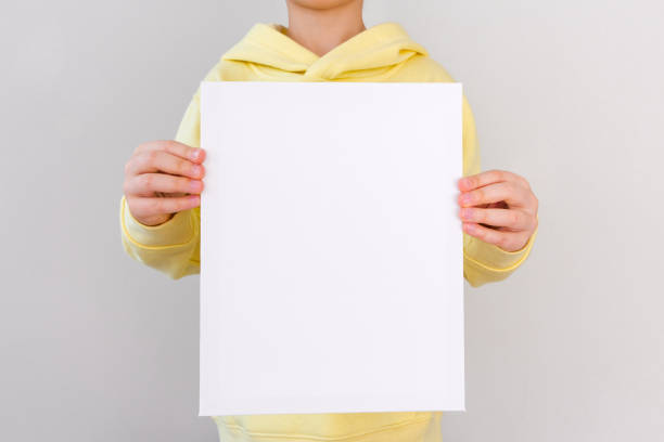 istock A blank canvas in the girl's hands. Template and mock up for design, copy space 2194997089