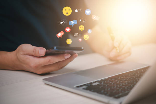 istock Hands using a smartphone with floating social media icons, representing digital interaction and online engagement. networking, communication, and real-time messaging in the modern world. 2195002045