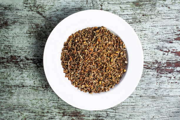 istock Cumin seeds resting in a white bowl on rustic wooden table 2195004598