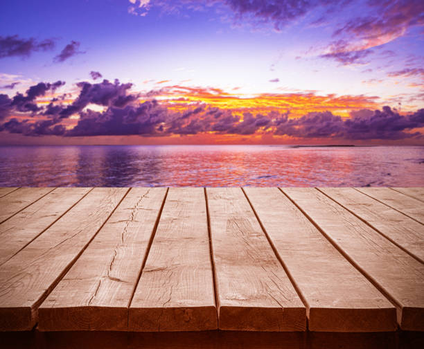 istock Empty wooden table top with tropical ocean sunset and dramatic sky background 2195005337