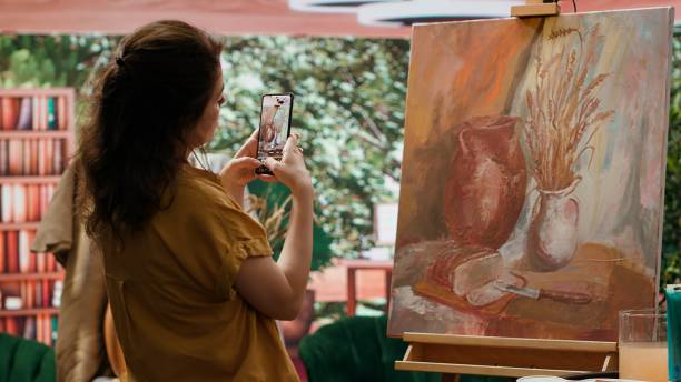 istock Painter is promoting her rustic masterpiece painting with the smartphone 2195006287