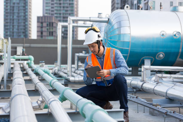 istock Male engineer work using digital tablet for checks or maintenance in sewer pipes area at construction site. Male plumber working in sewer pipes area at rooftop of building 2195008410