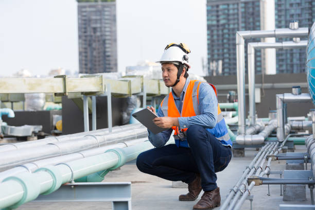 istock Male engineer work using digital tablet for checks or maintenance in sewer pipes area at construction site. Male plumber working in sewer pipes area at rooftop of building 2195008422