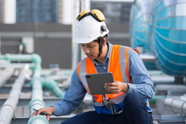 istock Male engineer work using digital tablet for checks or maintenance in sewer pipes area at construction site. Male plumber working in sewer pipes area at rooftop of building 2195008423