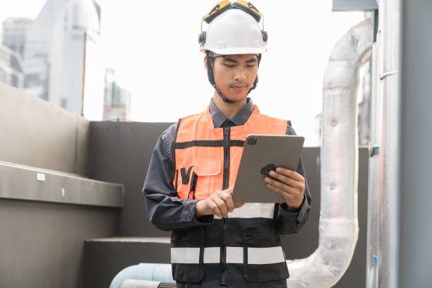 istock Male plumber engineer or technician worker working in sewer pipes area at construction site. Asian male plumber worker check or maintenance sewer pipes network system at construction site 2195008541
