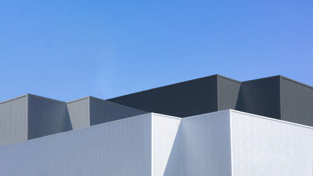 istock Factory industry, Warehouse Construction in Geometric Modern Design, Architecture Building with Aluminium Facade on Blue Sky Background, Backdrop Wall Metal Corrugated Steel Surface Pattern. 2195009755