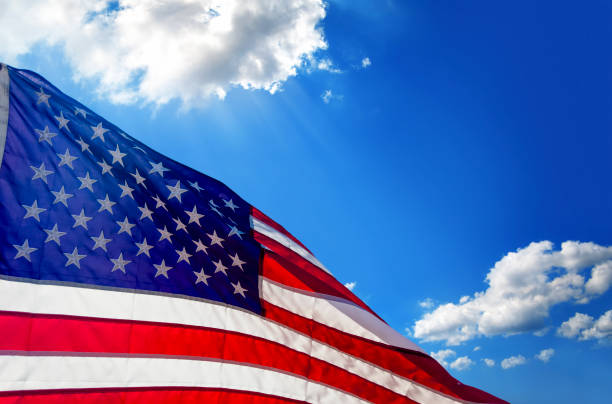 istock Close Up American Flag over sunny sky 2195011380