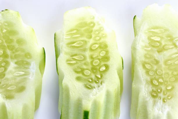 Slices of Cucumber vegetable - white background.