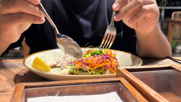 someone is about to eat their meal which contains salad