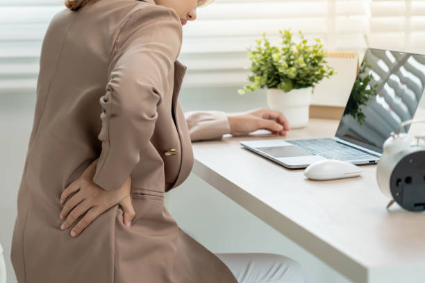 istock man holding her lower back while and suffer from unbearable pain health and problems, chronic back pain, backache in office syndrome, scoliosis, herniated disc, muscle inflammation 2195016182