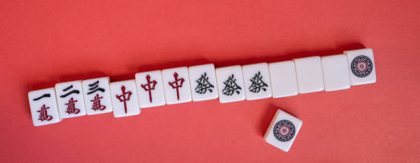istock Mahjong tiles lined up on a red background 2195016274