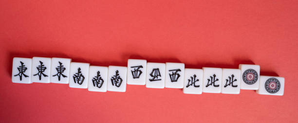 istock Mahjong tiles lined up on a red background 2195016283