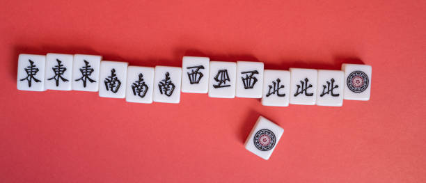 istock Mahjong tiles lined up on a red background 2195016291