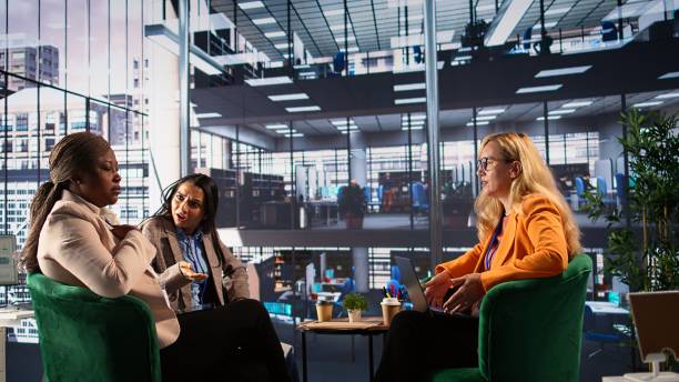 Multiethnic female managers getting in a fight and screaming at each other, angry and frustrated about the crisis. Businesswomen being furious and upset, disappointed enterprise failure. Camera B.
