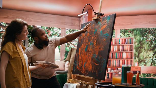 istock Talented artist and apprentice engage in finger painting in art workshop 2195018177