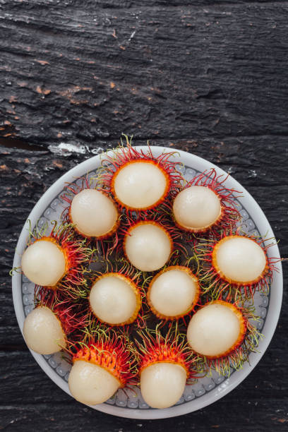 istock Longan on black wooden background 2195019207