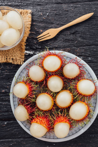 istock Longan on black wooden background 2195019213
