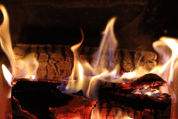 istock Close up of flames on logs in a fireplace 2195021225