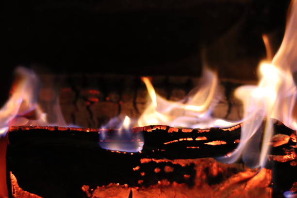 istock Close up of flames on logs in a fireplace 2195021275