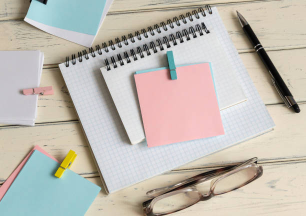 istock A blank post-it note on my notepad, next to my glasses and documents. Concept of business and finance. 2195021751