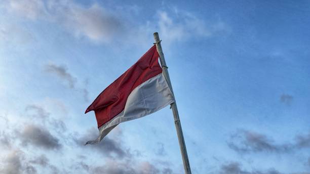istock the Indonesian flag fluttering in the blue sky 2195021831