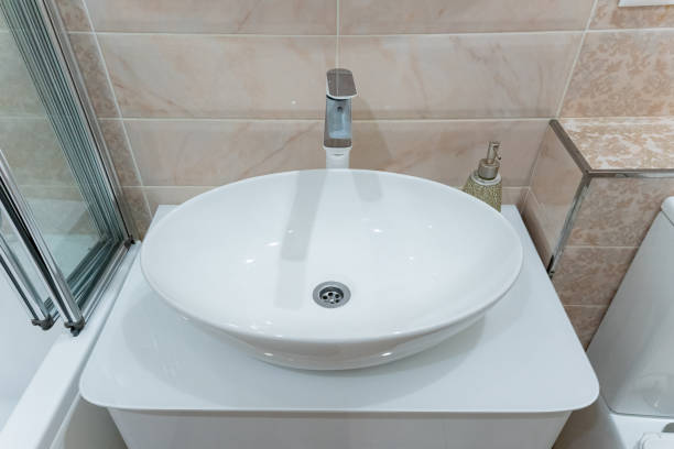 istock This is a modern white round bathroom sink featuring a sleek faucet, perfectly designed for a contemporary setting and elegant decor 2195025182