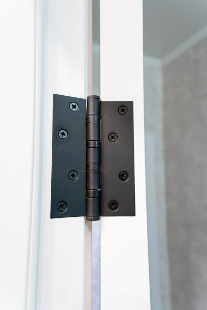 istock This is a close up image featuring a black door hinge mounted on a white door 2195025224