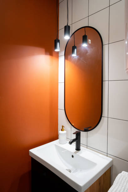 istock Explore the beauty of Modern Bathroom Design featuring a Stylish Sink, a chic Mirror, and Soft Ambient Lighting for a serene atmosphere 2195025265