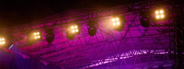 istock Bright spotlights mounted on metal truss. Professional stage lighting 2195025582