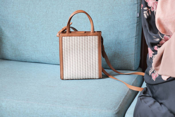 istock A Stylish Handbag rests elegantly on a Blue Couch, blending artistry and comfort beautifully 2195027780